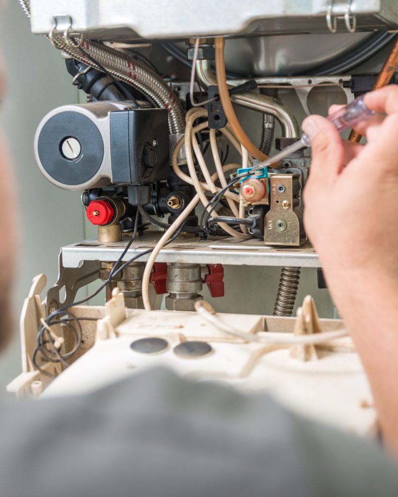 Technician repairing Gas Furnace.